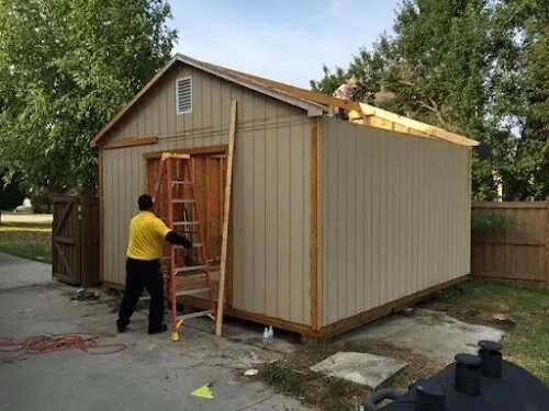 A Junk Doctors crew member taking down a shed